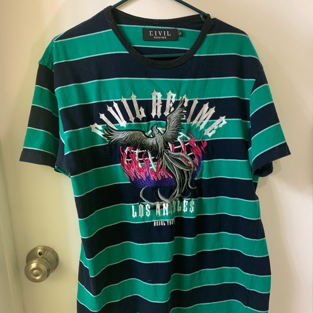 Striped shirt with design on front.